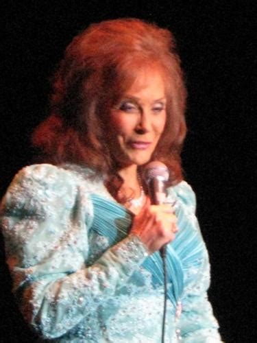 Examining the physical attributes that enhance Loretta Lynn's stage presence